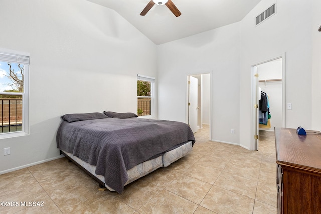 7746 S Trumpet Vine Ave, Tucson, AZ 85747 - bedroom with high vaulted ceiling, light tile patterned floors, a walk in closet, ceiling fan, and a closet