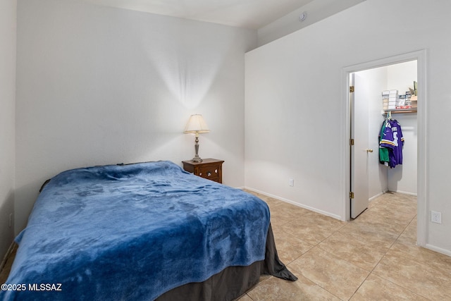 7746 S Trumpet Vine Ave, Tucson, AZ 85747 - bedroom featuring light tile patterned floors, a walk in closet, and baseboards