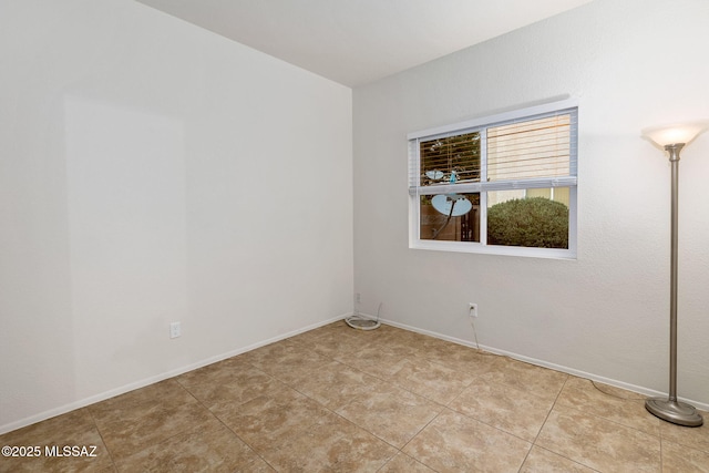 7746 S Trumpet Vine Ave, Tucson, AZ 85747 - spare room featuring light tile patterned floors and baseboards