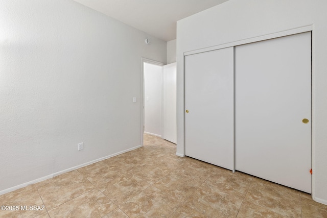 7746 S Trumpet Vine Ave, Tucson, AZ 85747 - unfurnished bedroom featuring a closet and baseboards