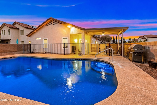7746 S Trumpet Vine Ave, Tucson, AZ 85747 - view of swimming pool with area for grilling, a fenced backyard, and a patio area