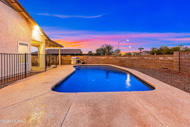 7746 S Trumpet Vine Ave, Tucson, AZ 85747 - view of swimming pool featuring a patio and a fenced backyard