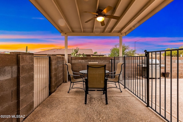 7746 S Trumpet Vine Ave, Tucson, AZ 85747 - patio terrace at dusk with ceiling fan, a fenced backyard, and outdoor dining area