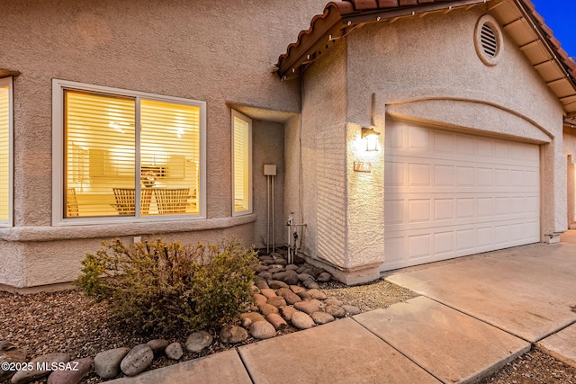 7746 S Trumpet Vine Ave, Tucson, AZ 85747 - view of front of property with stucco siding, driveway, and an attached garage