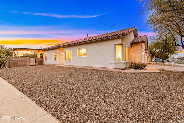 7746 S Trumpet Vine Ave, Tucson, AZ 85747 - view of front of house with a tile roof, stucco siding, and fence