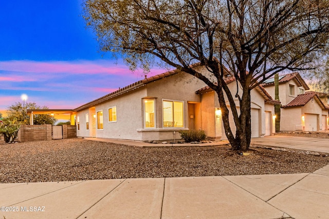 7746 S Trumpet Vine Ave, Tucson, AZ 85747 - mediterranean / spanish home with driveway, stucco siding, fence, a garage, and a tile roof