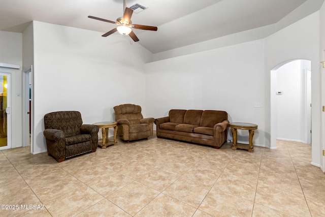 7746 S Trumpet Vine Ave, Tucson, AZ 85747 - living room featuring arched walkways, a ceiling fan, vaulted ceiling, and light tile patterned flooring