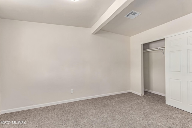 7932 E Winnepeg Dr, Tucson, AZ 85730 - unfurnished bedroom featuring carpet, baseboards, a closet, and beamed ceiling