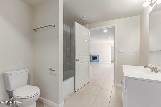 7932 E Winnepeg Dr, Tucson, AZ 85730 - bathroom with toilet, vanity, recessed lighting, a fireplace, and baseboards