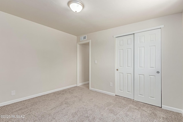 7932 E Winnepeg Dr, Tucson, AZ 85730 - unfurnished bedroom featuring carpet flooring, baseboards, and a closet