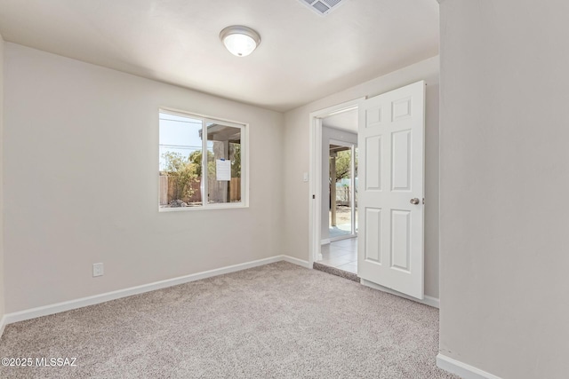 7932 E Winnepeg Dr, Tucson, AZ 85730 - carpeted empty room with plenty of natural light and baseboards