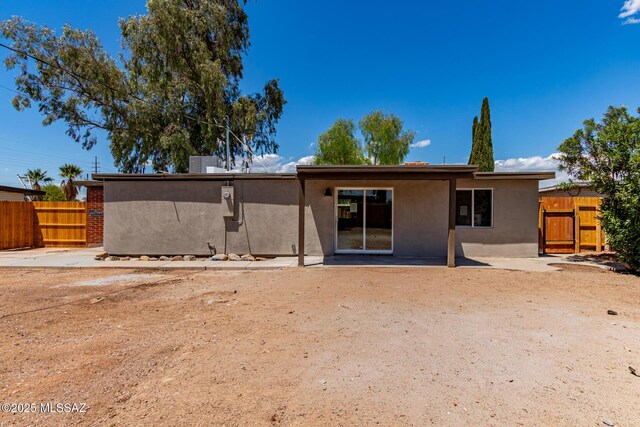 7932 E Winnepeg Dr, Tucson, AZ 85730 - back of property featuring stucco siding, fence, a gate, and a patio