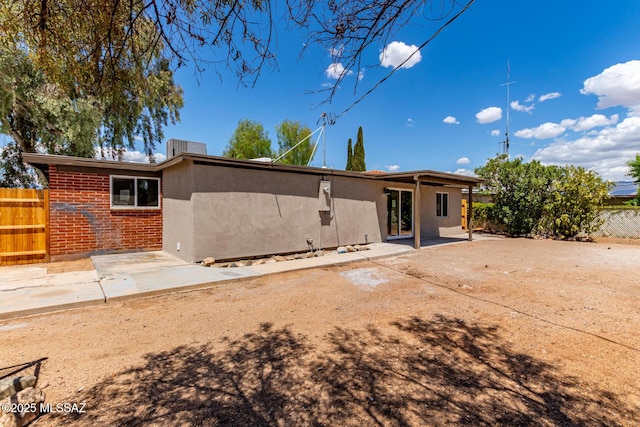 7932 E Winnepeg Dr, Tucson, AZ 85730 - rear view of house with a patio area, fence, and brick siding