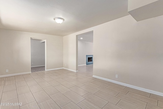 7932 E Winnepeg Dr, Tucson, AZ 85730 - empty room with a fireplace and baseboards