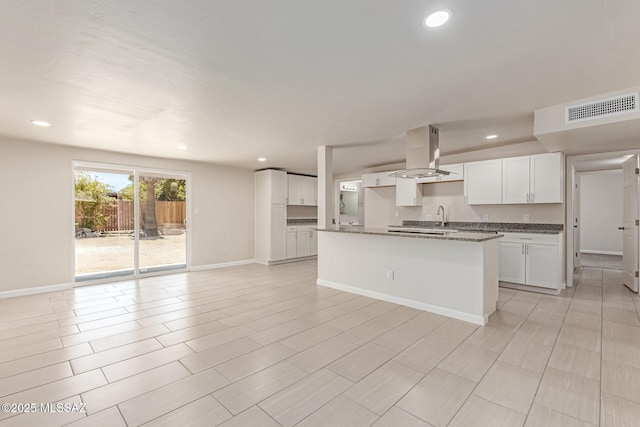 7932 E Winnepeg Dr, Tucson, AZ 85730 - kitchen with island exhaust hood, white cabinetry, open floor plan, baseboards, and recessed lighting