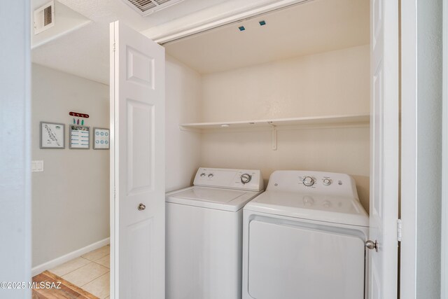 5855 N Kolb Rd Unit 1102, Tucson, AZ 85750 - clothes washing area featuring washing machine and dryer, light tile patterned floors, and baseboards