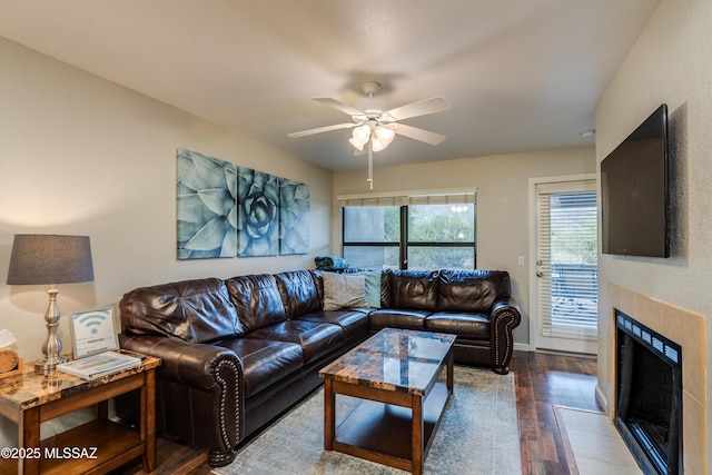 5855 N Kolb Rd Unit 1102, Tucson, AZ 85750 - living area featuring hardwood / wood-style floors, a ceiling fan, a fireplace, and baseboards