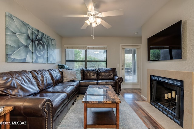5855 N Kolb Rd Unit 1102, Tucson, AZ 85750 - living area featuring wood finished floors, ceiling fan, and a fireplace with flush hearth