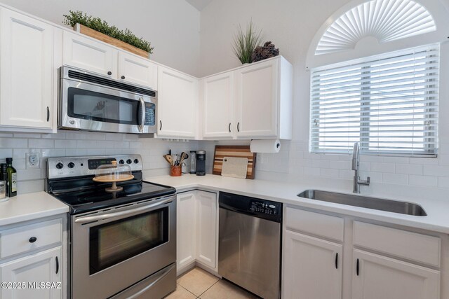 8912 E Desert Aire St, Tucson, AZ 85730 - kitchen with stainless steel appliances, a sink, backsplash, white cabinetry, and light countertops
