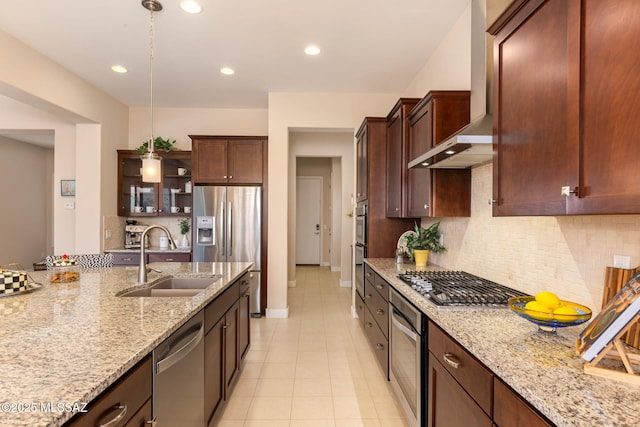 6719 W Kaibab Trl, Marana, AZ 85658 - kitchen featuring stainless steel appliances, a sink, wall chimney range hood, backsplash, and light stone countertops