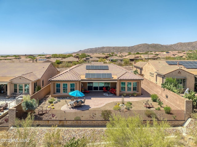 6719 W Kaibab Trl, Marana, AZ 85658 - rear view of house with a fenced backyard, a tile roof, a patio area, solar panels, and a residential view
