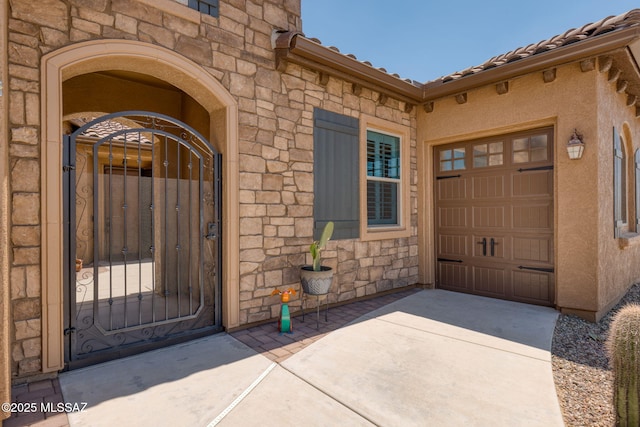 6719 W Kaibab Trl, Marana, AZ 85658 - entrance to property with stone siding, a gate, a garage, and driveway
