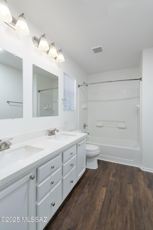 6775 S Aquiline Dr, Tucson, AZ 85756 - full bathroom with bathtub / shower combination, double vanity, and wood finished floors