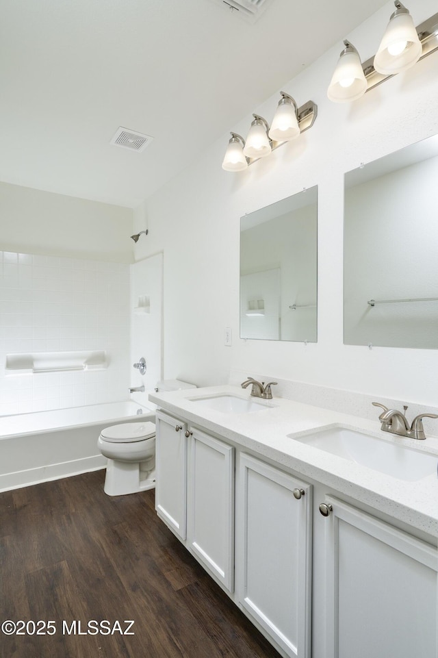 6775 S Aquiline Dr, Tucson, AZ 85756 - bathroom featuring double vanity, wood finished floors, and bathing tub / shower combination