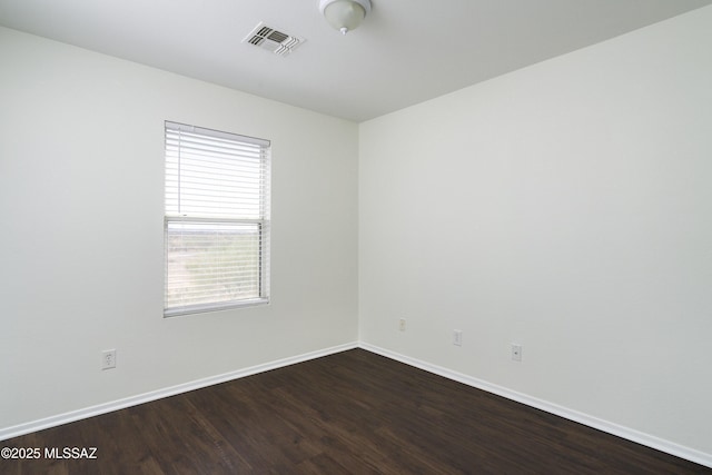 6775 S Aquiline Dr, Tucson, AZ 85756 - spare room featuring dark wood finished floors and baseboards