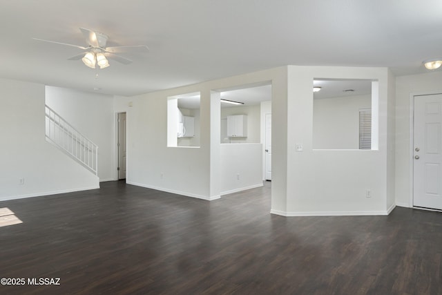 6775 S Aquiline Dr, Tucson, AZ 85756 - unfurnished living room with dark wood finished floors, a ceiling fan, and stairway