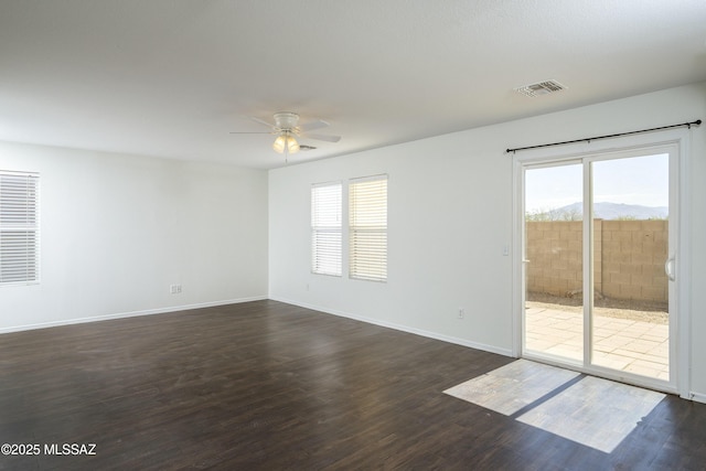 6775 S Aquiline Dr, Tucson, AZ 85756 - empty room featuring ceiling fan, healthy amount of natural light, and dark wood-type flooring