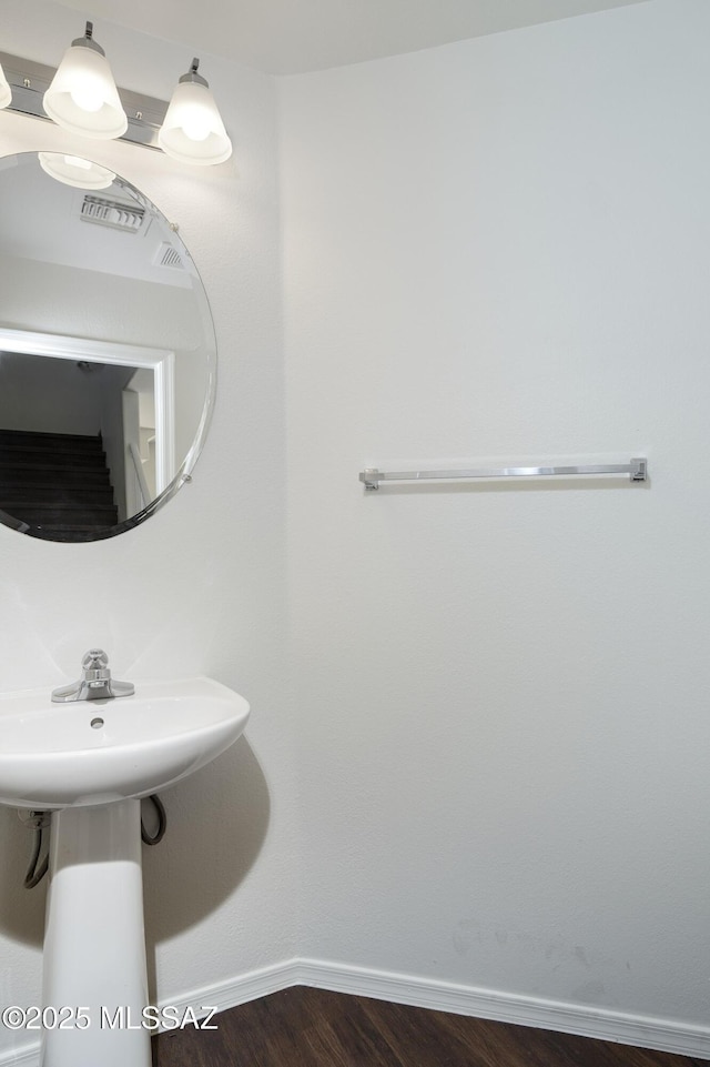 6775 S Aquiline Dr, Tucson, AZ 85756 - bathroom featuring baseboards and wood finished floors
