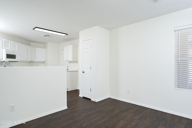 6775 S Aquiline Dr, Tucson, AZ 85756 - spare room featuring dark wood-type flooring and baseboards