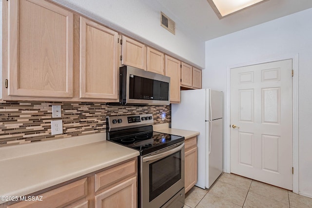 7050 E Sunrise Dr Unit 12106, Tucson, AZ 85750 - kitchen with stainless steel appliances, light brown cabinetry, backsplash, light tile patterned flooring, and light countertops