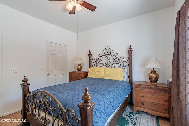 7050 E Sunrise Dr Unit 12106, Tucson, AZ 85750 - bedroom with wood finished floors, a ceiling fan, and baseboards