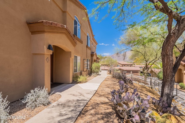 7050 E Sunrise Dr Unit 12106, Tucson, AZ 85750 - view of side of home with stucco siding and fence