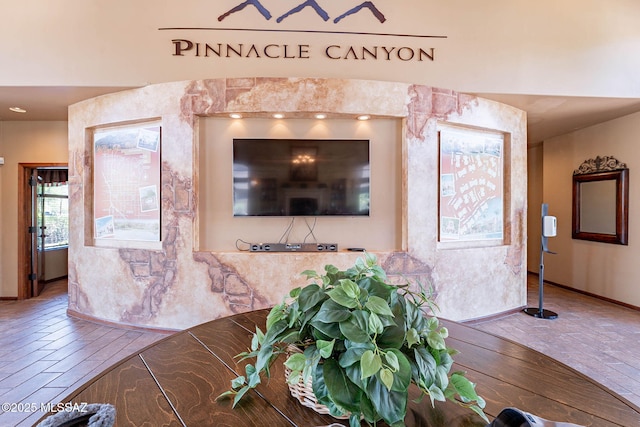 7050 E Sunrise Dr Unit 12106, Tucson, AZ 85750 - living area featuring baseboards and wood finished floors