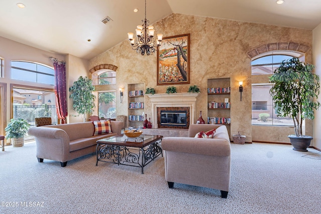 7050 E Sunrise Dr Unit 12106, Tucson, AZ 85750 - carpeted living room with high vaulted ceiling, plenty of natural light, a chandelier, recessed lighting, and a glass covered fireplace
