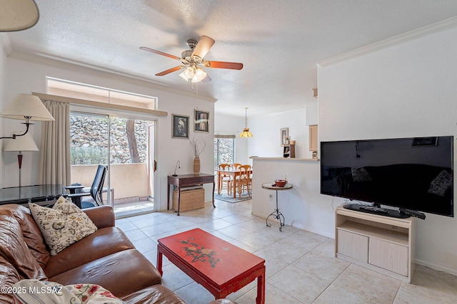 7050 E Sunrise Dr Unit 12106, Tucson, AZ 85750 - living area featuring a ceiling fan, crown molding, healthy amount of natural light, a textured ceiling, and light tile patterned flooring
