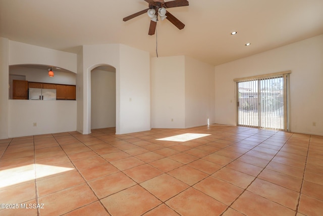 5426 N Willow Thicket Way, Tucson, AZ 85704 - empty room with a ceiling fan, light tile patterned floors, arched walkways, recessed lighting, and high vaulted ceiling