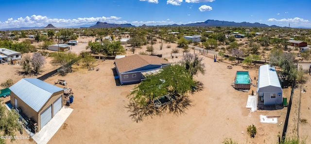 aerial view of property and surrounding area with a mountain backdrop and a desert landscape