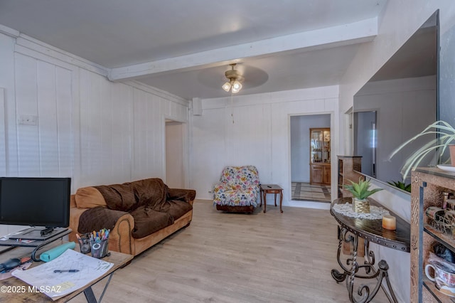 living room with beamed ceiling, wood finished floors, and a ceiling fan
