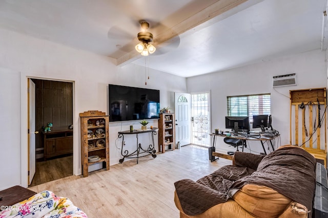 living area with beamed ceiling, wood finished floors, a desk, and a ceiling fan