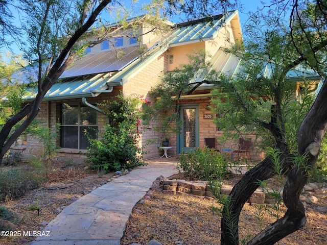 3025 N Gaia Pl, Tucson, AZ 85745 - view of front of house featuring solar panels, metal roof, and stucco siding
