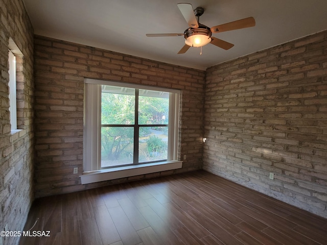 3025 N Gaia Pl, Tucson, AZ 85745 - empty room with ceiling fan, dark wood-type flooring, and brick wall