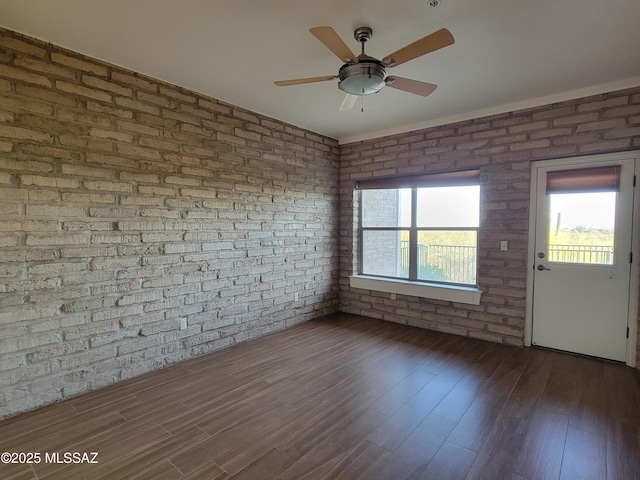 3025 N Gaia Pl, Tucson, AZ 85745 - empty room with a ceiling fan, wood finished floors, and brick wall