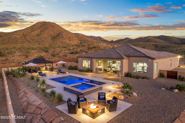 10465 E Ocotillo Rim Trl, Vail, AZ 85641 - view of swimming pool featuring a gazebo, an outdoor living space with a fire pit, a patio area, and a mountain view