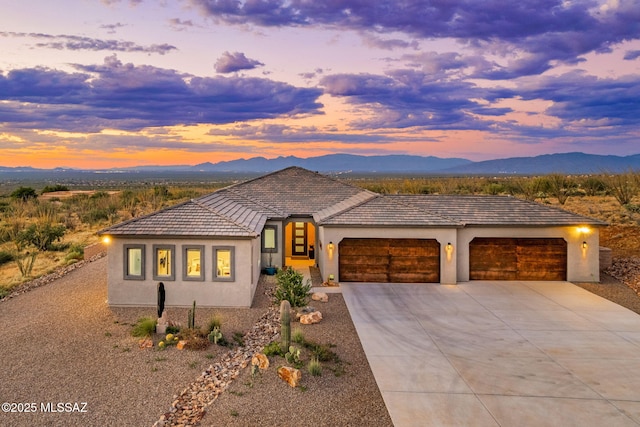 10465 E Ocotillo Rim Trl, Vail, AZ 85641 - view of front of home with driveway, a mountain view, a garage, and stucco siding