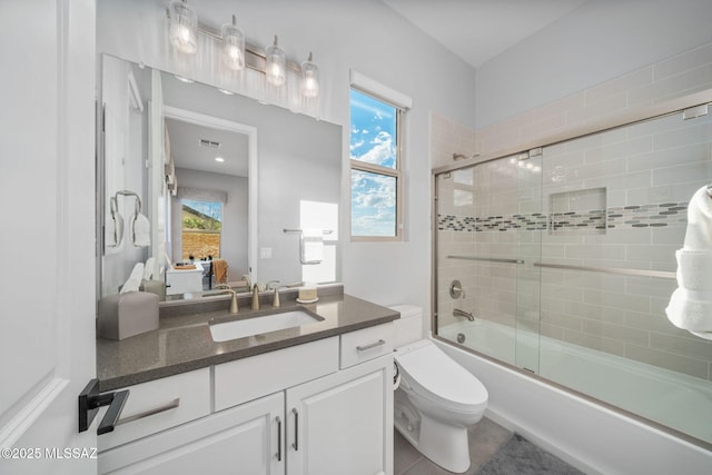 10465 E Ocotillo Rim Trl, Vail, AZ 85641 - ensuite bathroom with toilet, shower / bath combination with glass door, plenty of natural light, and vanity