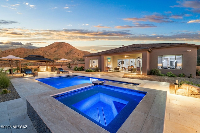10465 E Ocotillo Rim Trl, Vail, AZ 85641 - view of pool with an in-ground hot tub, a mountain view, and a patio area